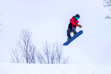 Fototapeta na wymiar People are enjoying downhill skiing and snowboarding