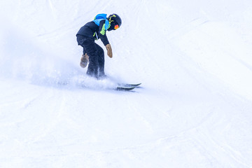 People are enjoying downhill skiing and snowboarding	