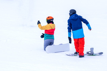 People are enjoying downhill skiing and snowboarding	