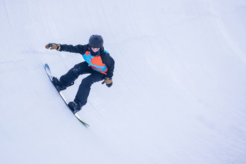 Fototapeta na wymiar People are enjoying half-pipe skiing / snowboarding