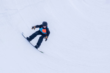 People are enjoying half-pipe skiing	/ snowboarding