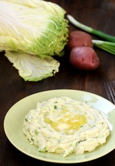 Colcannon Irish Mashed Potatoes St Patrick day food. puree with green onions and butter. copy space. top view