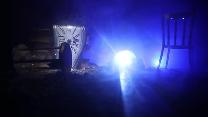 Time concept. Silhouette of a man standing between hourglasses with smoke and lights on a dark background. Surreal decorated picture