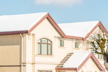 A perfect neighbourhood. Houses in suburb at Winter in the north America. Luxury houses covered nice snow. 