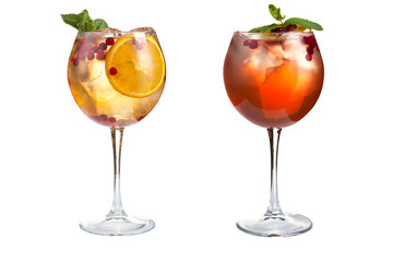 Two light cocktails with mint, fruits and berries on a white background. Cocktails in glass goblets.