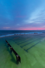 Obraz premium Bronte rock pool view with sunrise sky.