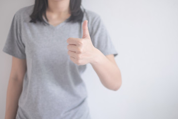 beautiful Asian woman showing thumbs up isolated on a white background with copy space