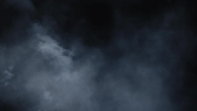 Spooky magic halloween. Atmospheric smoke VFX element. Haze background. Abstract smoke cloud. Smoke in slow motion on black background. White smoke slowly floating through space against black bg