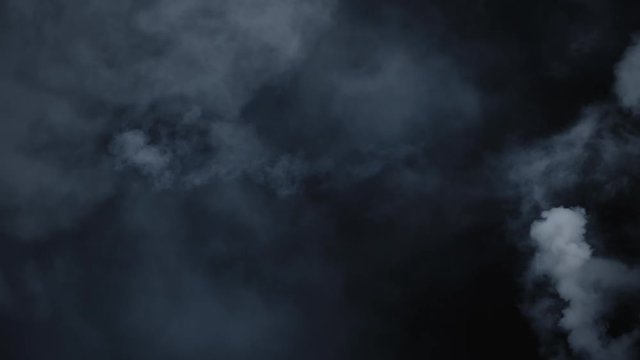 Spooky magic halloween. Atmospheric smoke VFX element. Haze background. Abstract smoke cloud. Smoke in slow motion on black background. White smoke slowly floating through space against black bg