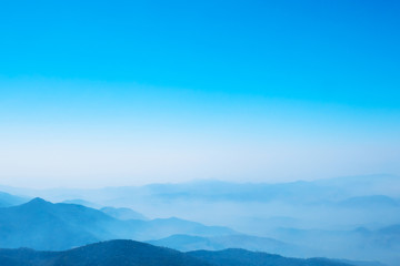 The mountains and forests with blue sky and white clouds at the peak of Inthanon national park (park name) in Chiang Mai province , Thailand in a foggy or misty day , real photo not graphic program.  