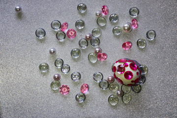 Easter composition flatlay. Easter eggs decorated with shiny rhinestones on  silver background with glass ornaments and pearl beads.