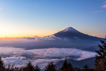 Fototapeta na wymiar Fuji mountain and the mist over Lake Kawaguchiko at beautiful sunrise , Yamanashi, Japan, Mount Fuji or Fujisan located on Honshu Island, is the highest mountain in Japan.