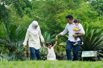 Fototapeta premium happy family concept with enjoying expression face,having fun at public park.