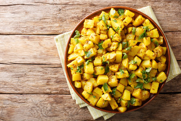 Jeera Aloo is a popular Indian side dish made with potatoes and cumin seeds close-up on a plate. horizontal top view
