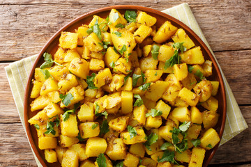 Jeera aloo recipe simple, delicious potatoes sauteed in mild spices close-up on a plate. horizontal top view