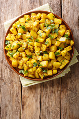 Jeera Aloo is a popular Indian side dish made with potatoes and cumin seeds close-up on a plate. Vertical top view