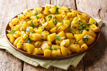 Dhaba Style Punjabi Jeera Aloo Recipe with spices close-up on a plate. Horizontal