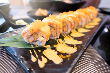 Closeup Sushi roll with fresh salmon on plate . Japanese style Food .