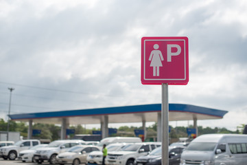 Lady parking sign at the gas station.