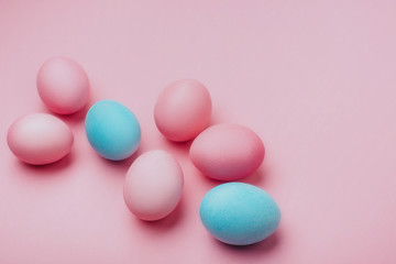 Fototapeta na wymiar Colored Easter eggs on a pink background. Copy space