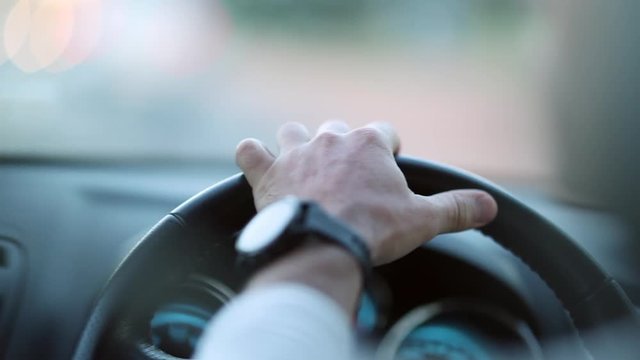 Hands holding steering wheel driving