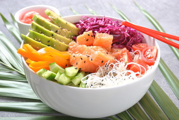 Fresh seafood recipe. Organic food. Fresh salmon poke bowl with crystal noodles, fresh red cabbage, avocado, cherry tomatoes. Food concept poke bowl 