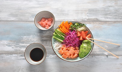 Fresh seafood recipe. Organic food. Fresh salmon poke bowl with crystal noodles, fresh red cabbage, avocado, cherry tomatoes. Food concept poke bowl 