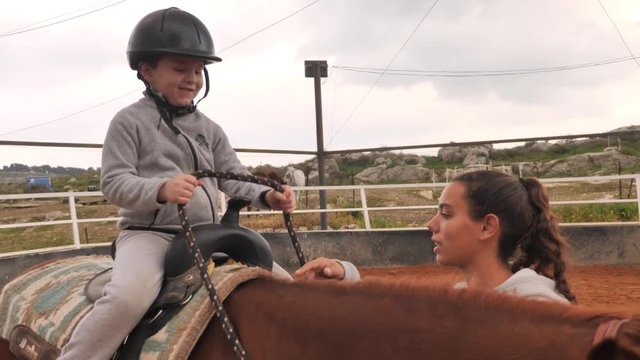 Equine-assisted therapy high five on horse