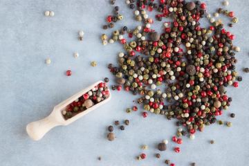 A mixture of peppers on a gray background.