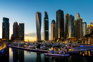 Dubai marina modern skyscrapers and luxury yachts at sunset