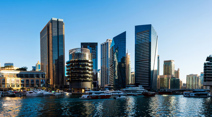 Fototapeta na wymiar Dubai marina modern skyscrapers and luxury yachts on a sunny day