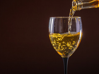 white wine pouring glass