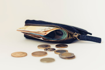 Black suede leather wallet isolated on white background with euro and coins .