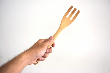 Male hand holding a jar of spice on white background