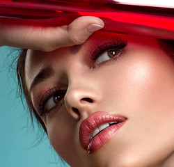 Beautiful fashion woman with  a colored  items.  Attractive white girl with living coral makeup.