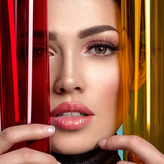 Beautiful fashion woman with  a colored  items.  Attractive white girl with living coral makeup.