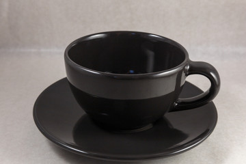 Dark coffee cup on white background.