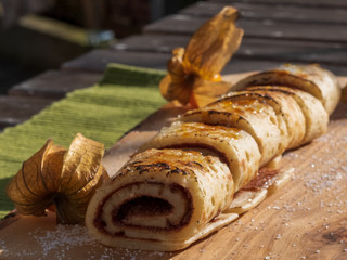 Pancake with flambeed sugar and physalis food art at outdoor environment