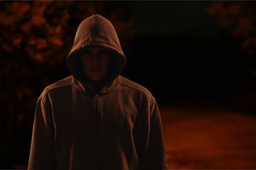 Thief in black clothes on grey background