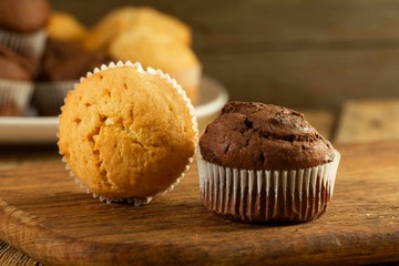 Chocolate cake and nut cake, homemade cakes on wooden background