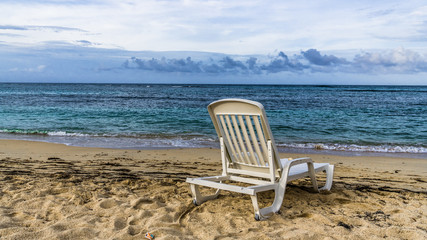 Chair on a deserted Caribbean beach