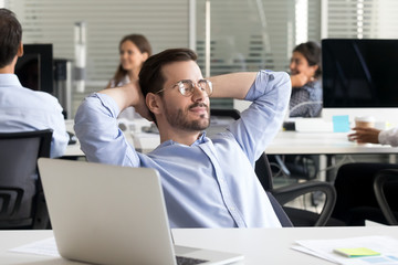 Employee resting with closed eyes in coworking office