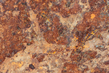 Brown tin wall with rust and peeled paint