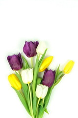 Fototapeta premium Flowers composition background. bouquet of purple violet, yellow, white tulips on a white background. top view. copy space. Flowers pattern