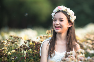 Beautiful girl and flowers field.