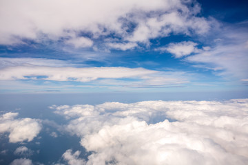 White cloud and blue sky at atmosphere Level, photo taken through the plane window