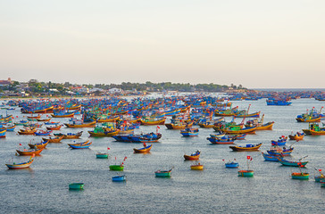 View from the mountains to the port with fishing boats near the fishing village, sunset time, evening colors. Asia, Village Mui Ne, Phan Thiet, Vietnam, February.