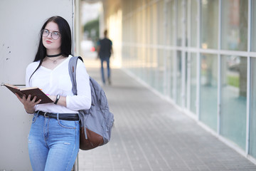 Girl student on the street with books