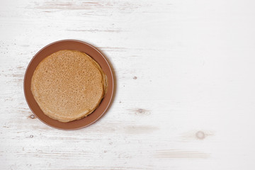 Gluten free pancakes on white wooden background.