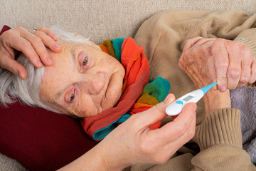 Sick elderly woman on the sofa